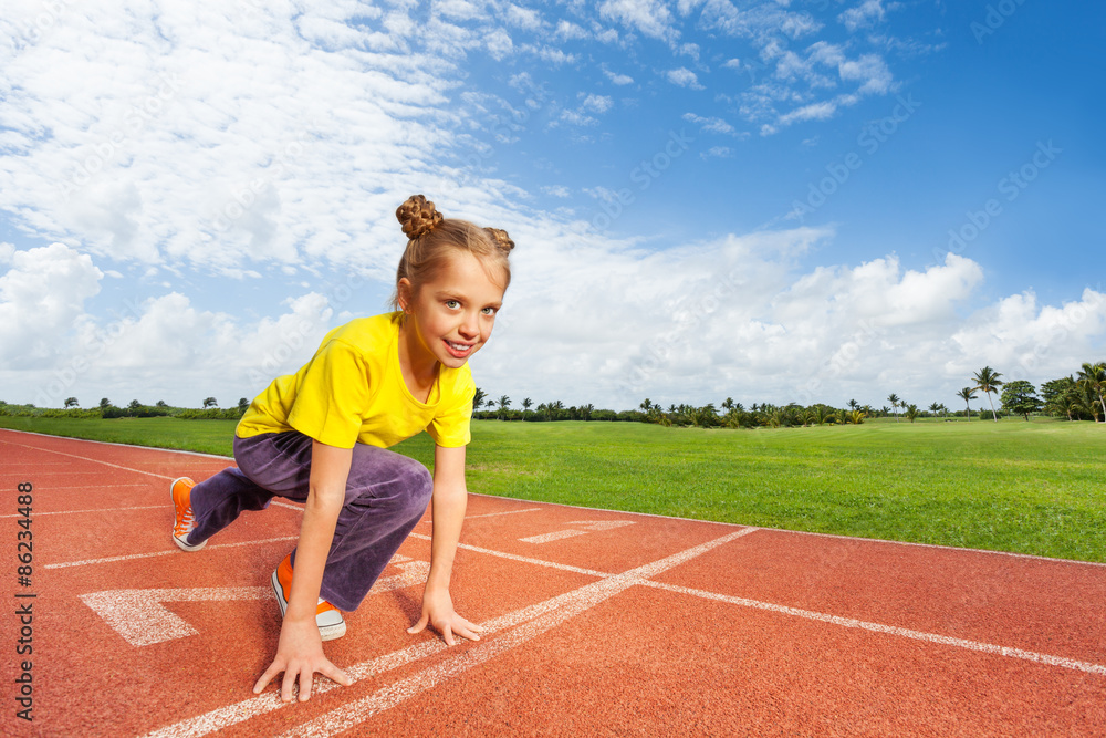 Fototapeta premium Girl in colorful uniform on start ready to run