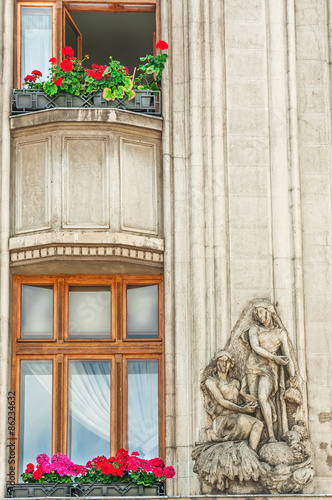 Nostalgic facade  window with statue  Brasov  Romania