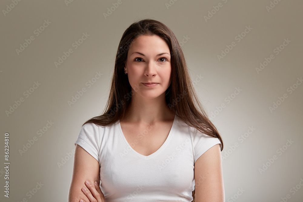 Portrait of serious young woman with long brunette hair Portrait of serious young woman with long brunette hair
