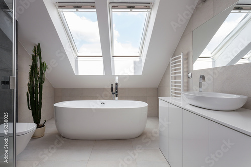 Freestanding bath in white bathroom photo