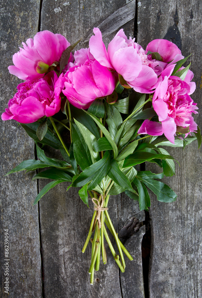 beautiful fresh peonies on wooden surface