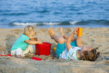 girls at  seaside playing with sand