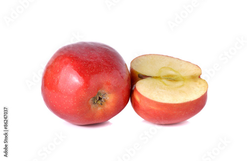 whole and half cut red apples with stem on white background