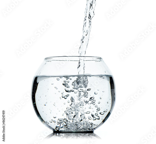 Water splashing from glass on white background