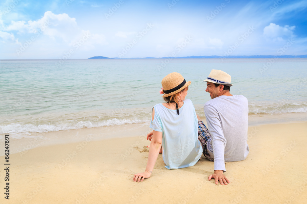 Young man and a woman relaxing on the beach Young man and a woman relaxing on the beach