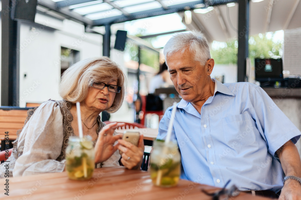 Mature Couple In Cafe Using Technology Mature Couple In Cafe Using Technology