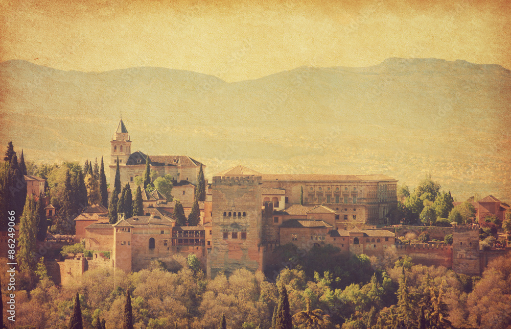 View of the Alhambra from the Albayzin of Granada,  Andalusia, Spain. Photo in retro style.  Paper texture.