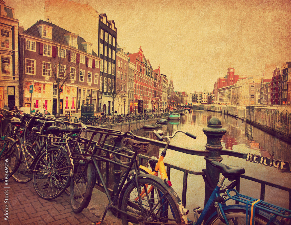  Amsterdam. The Singel is one of the numerous canals in Amsterdam, Netherlands .Photo in retro style. Added paper texture. Toned image