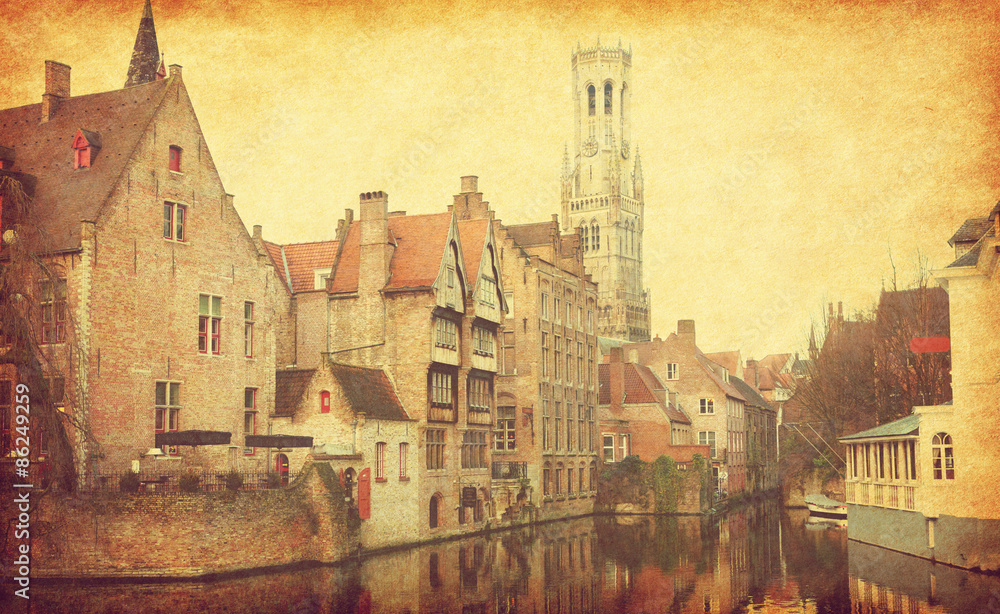 Obraz premium Bruges historic centre. The classic view from the Rozenhoedkaai, Belgium. Photo in retro style. Added paper texture