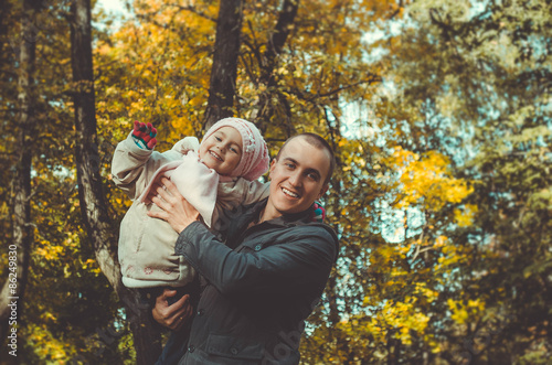 young father with a toddler in the autumn park