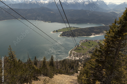 A view over a lake and the cables for a cableway