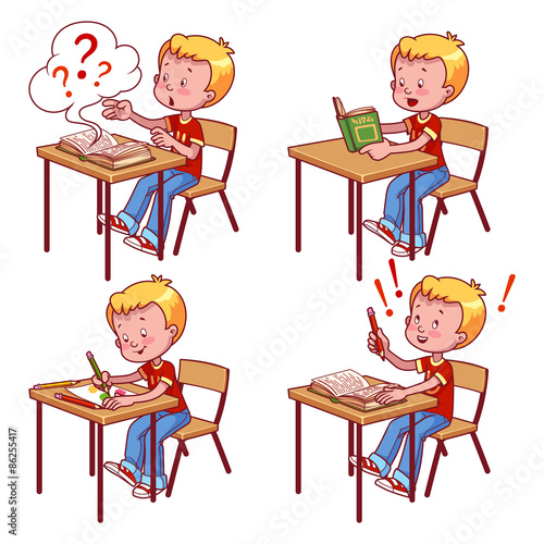 Cute schoolboy behind a school desk.