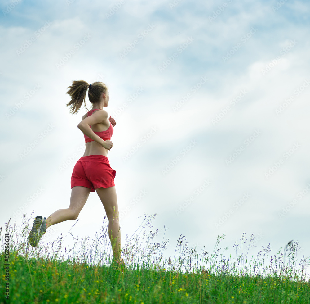 Young woman running summer park rural road. Outdoor exercises. J Young woman running summer park rural road. Outdoor exercises. J