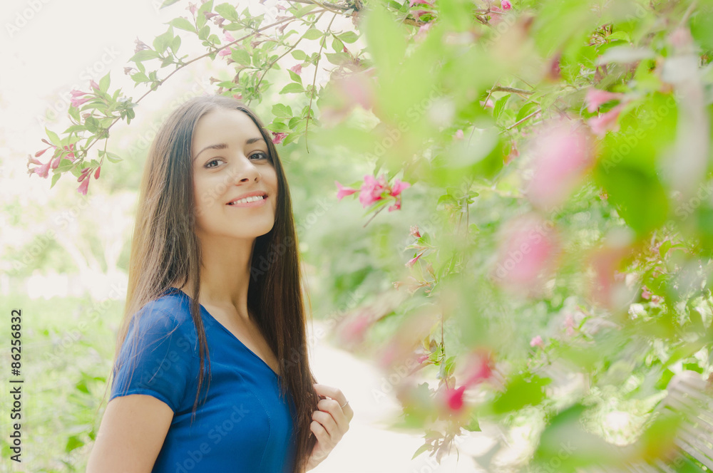 Beautiful happy young woman smiling summer blooming trees Beautiful happy young woman smiling summer blooming trees
