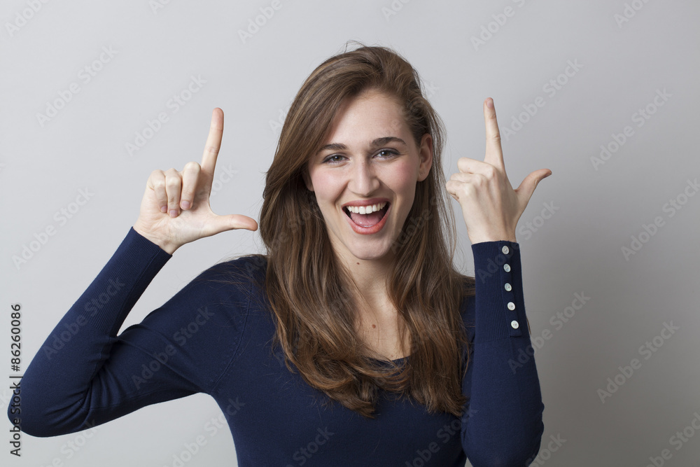 Φωτογραφία gorgeous smiling young girl making the LOL sign for abbreviation of smile and la