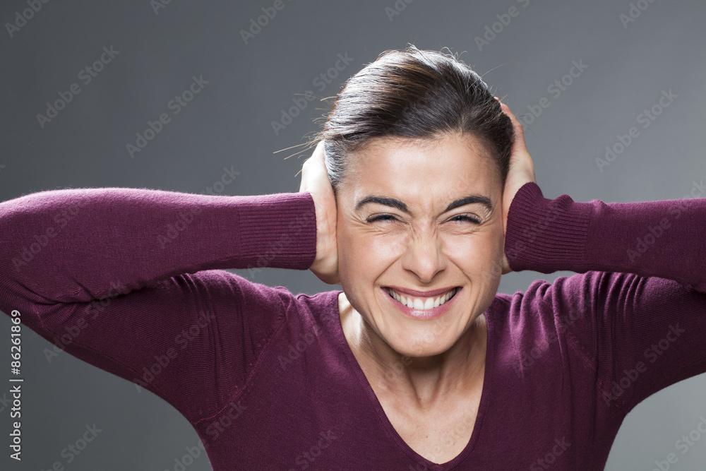 raging young woman covering closed ears, annoyed by loud noise, ignoring someone, not wanting to hear their side of story or having painful headache raging young woman covering closed ears, annoyed by loud noise, ignoring someone, not wanting to hear their side of story or having painful headache