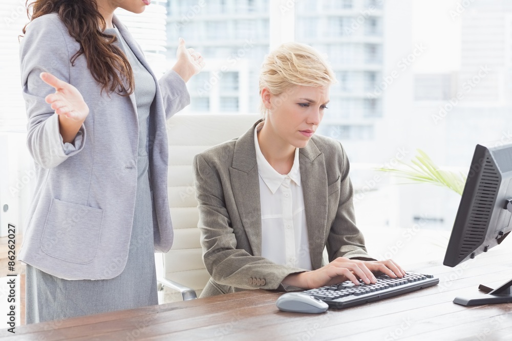 Businesswoman giving orders at her coworker Businesswoman giving orders at her coworker