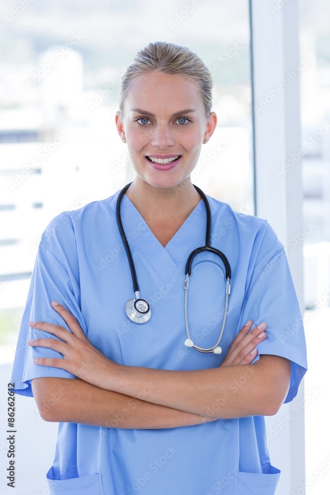 Happy doctor looking at camera with arms crossed Happy doctor looking at camera with arms crossed