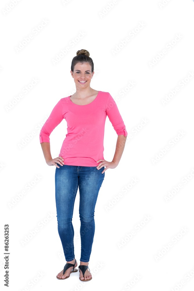 Happy pretty casual brunette looking at camera with hands on hip Happy pretty casual brunette looking at camera with hands on hip