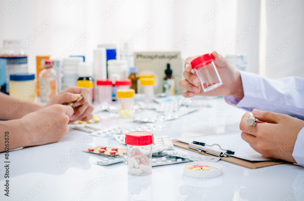 two pharmacists preparing medicine container in a pharmacy
two pharmacists preparing medicine container in a pharmacy
