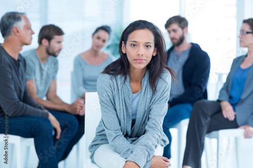 Woman comforting another in rehab group at therapy photo