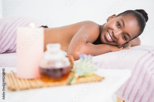 Pretty woman lying on massage table smiling at the camera