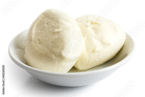Two balls of mozzarella cheese in a dish, isolated on white.