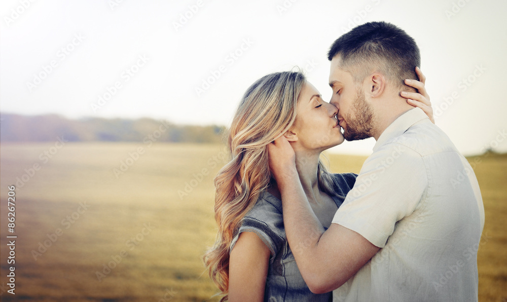 stunning sensual young couple in love kissing at the sunset in s