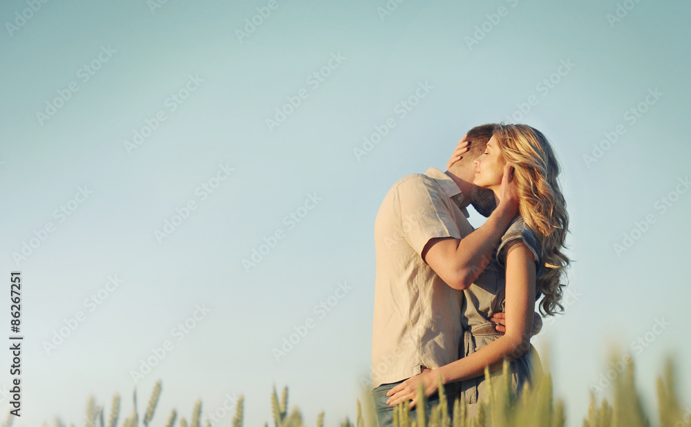 stunning sensual young couple in love embracing at the sunset in Stock