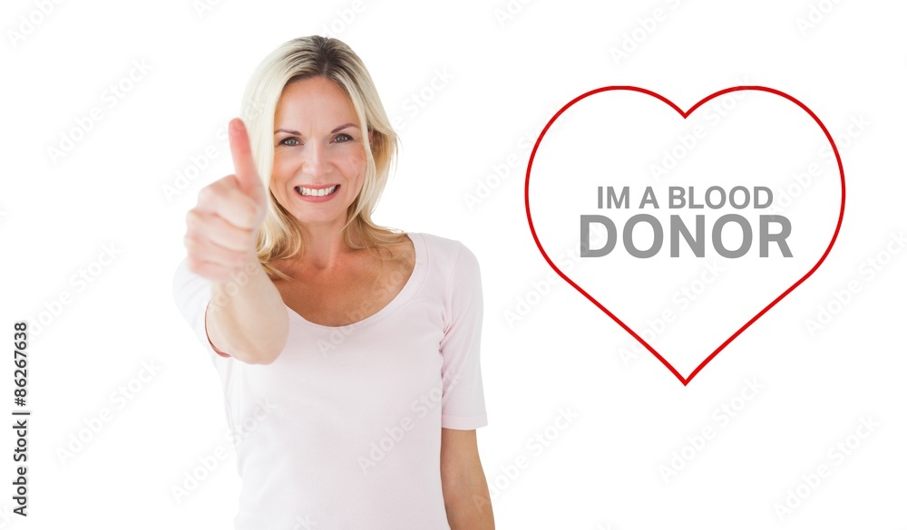 Composite image of happy blonde showing thumbs up and smiling at camera Composite image of happy blonde showing thumbs up and smiling at camera