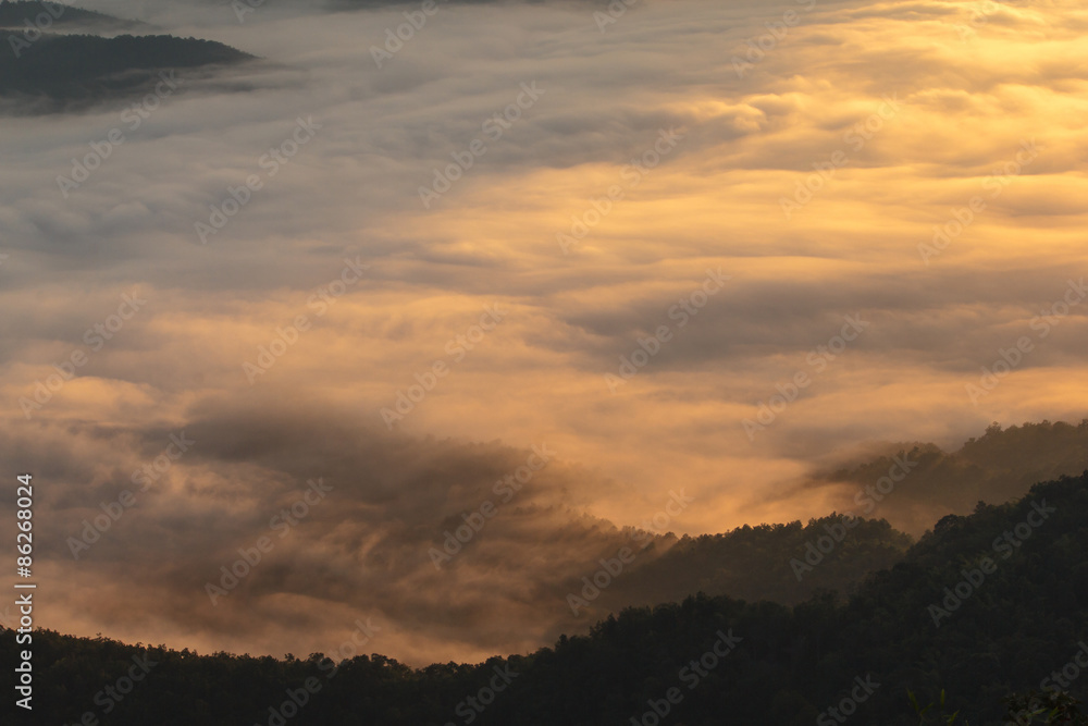 Layer of mountains in the mist at sunrise time