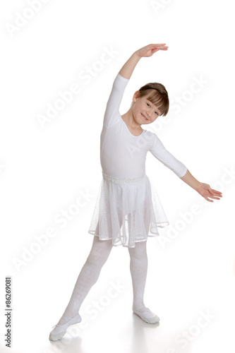 Girl gymnast in white bikini doing sport exercises