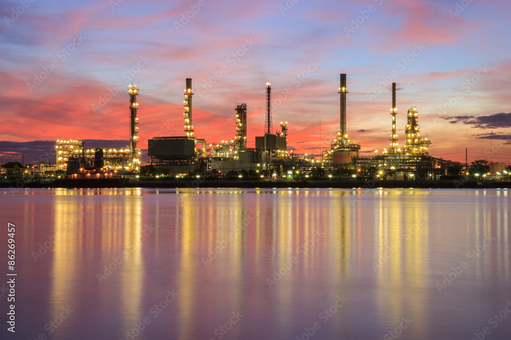 Oil refinery factory in silhouette and sunrise sky