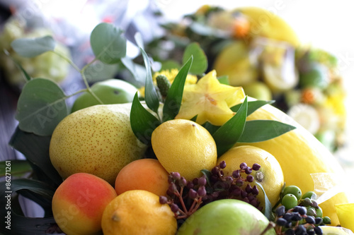bouquet of fruits  apples  grapes  lemon  lime tangerine  melon  physalis  apricot