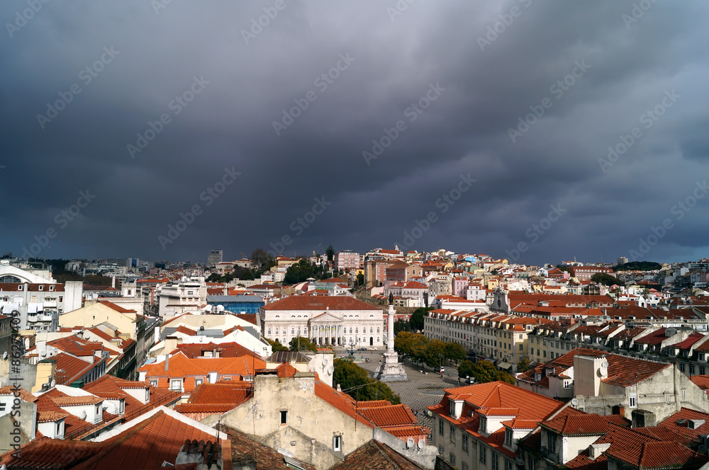 Sunny view of Lisbon under a dark cloudy sky