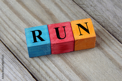 word run on colorful wooden cubes photo