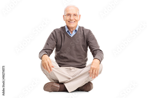 Cheerful senior sitting on the floor