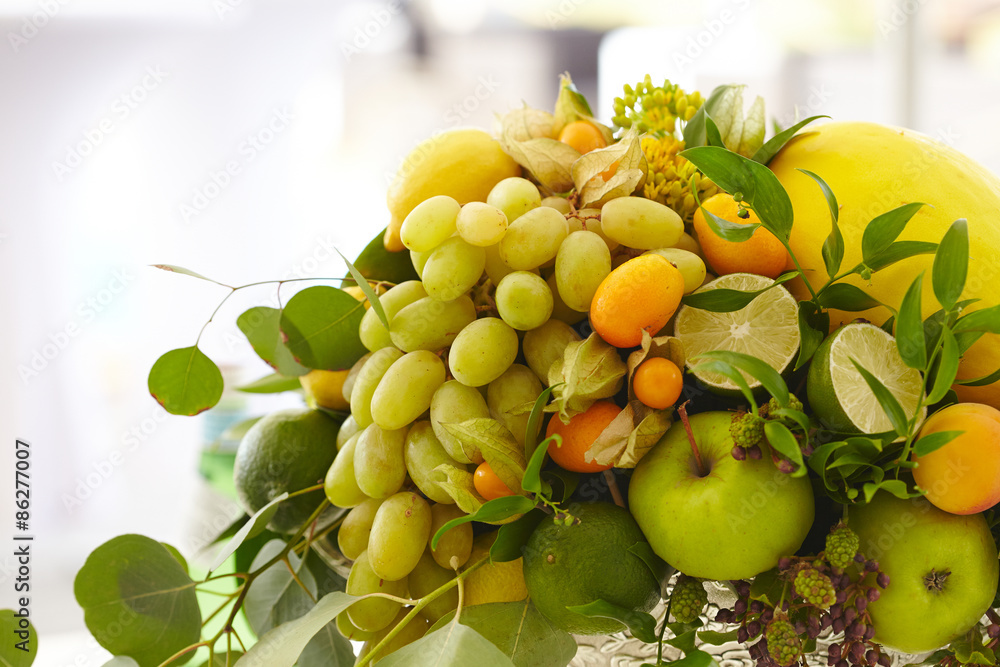 Fruit basket close-up: bananas, apples, grapes, apricots, melon,