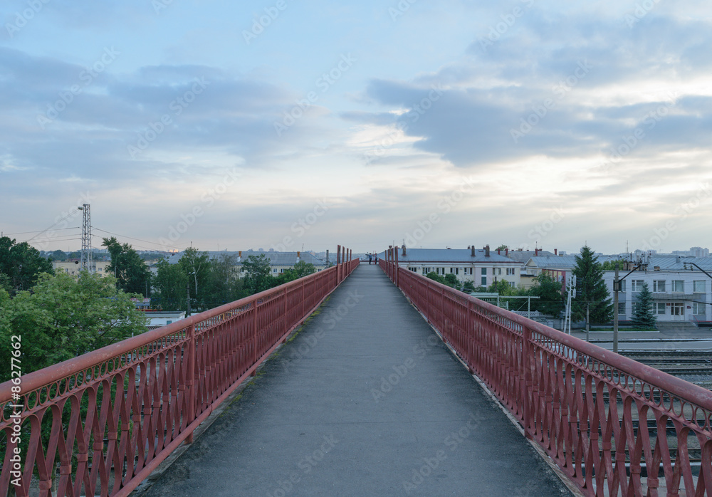 Tall and long pedestrian bridge over the railroad tracks