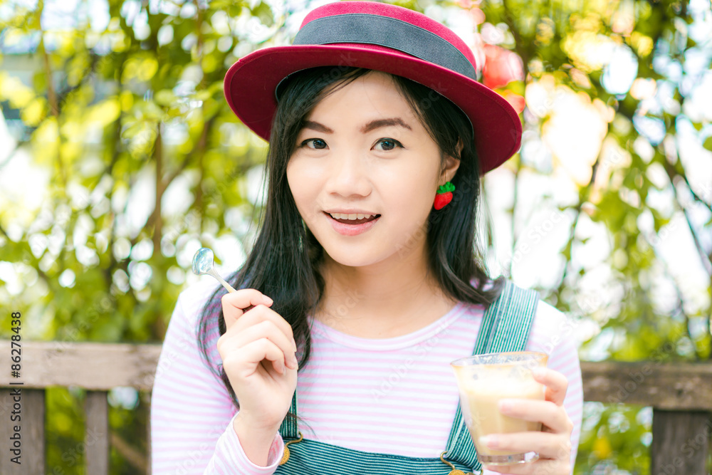 Beautiful young asian girl in outdoor cafe drinking coffee. Beautiful young asian girl in outdoor cafe drinking coffee.