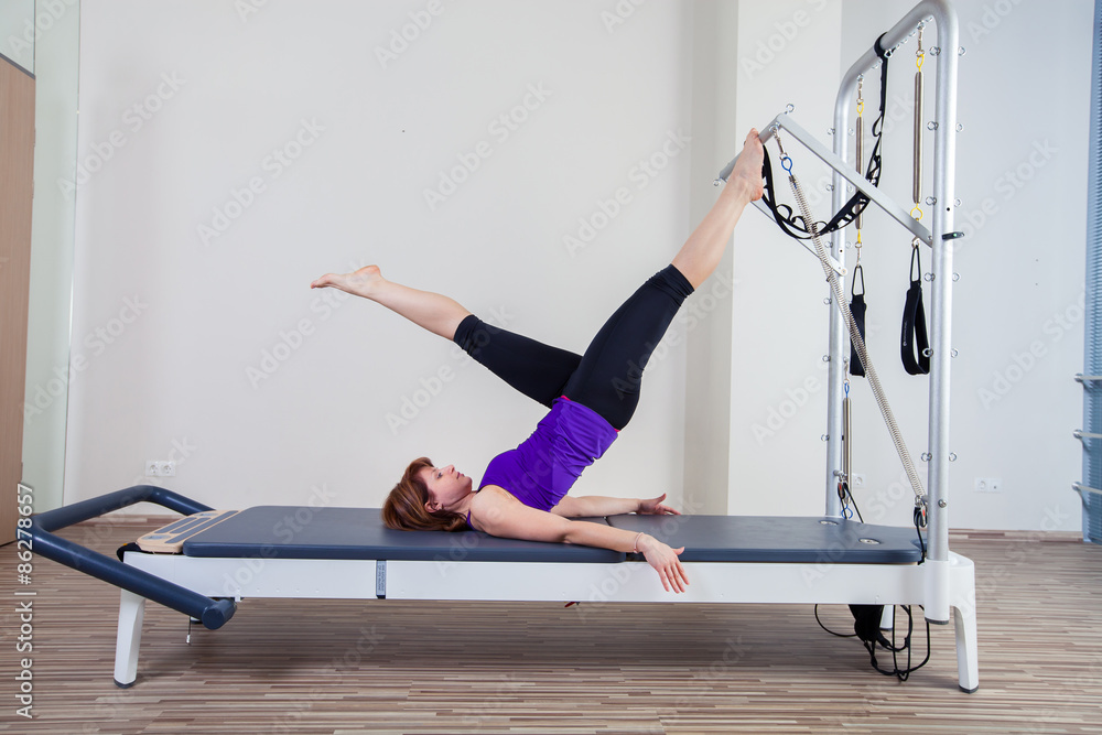 gym woman pilate instructor stretching in reformer bed