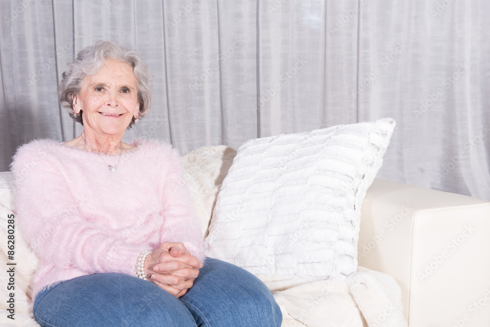 active female senior relaxing on couch active female senior relaxing on couch