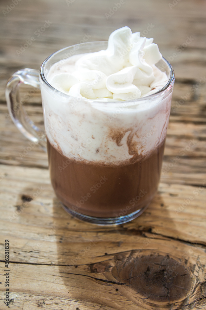 chocolate drink with whipped cream in transparent cup on wooden chocolate drink with whipped cream in transparent cup on wooden