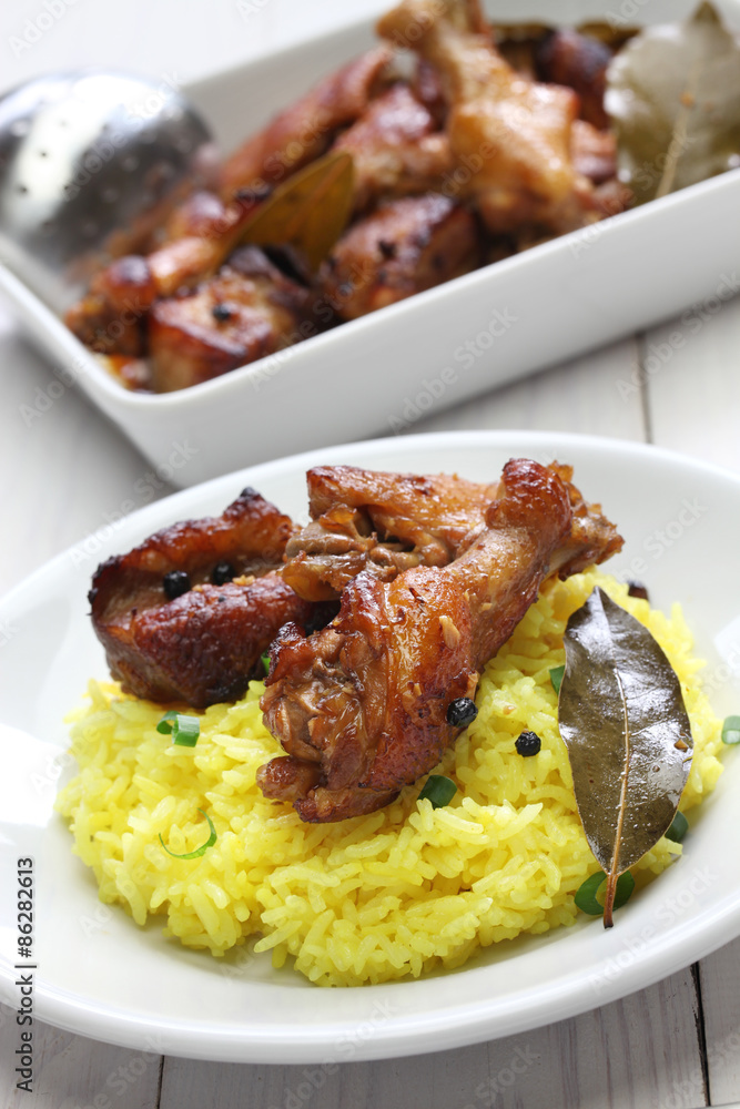 chicken and pork adobo over yellow rice, filipino food chicken and pork adobo over yellow rice, filipino food