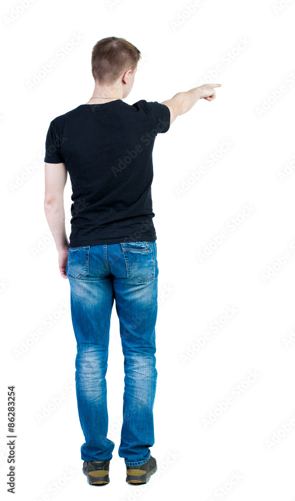 Back view of pointing young men in shirt and jeans. Young guy Back view of pointing young men in shirt and jeans. Young guy