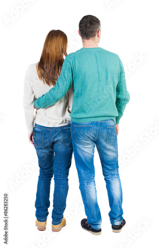 Back view of young embracing couple