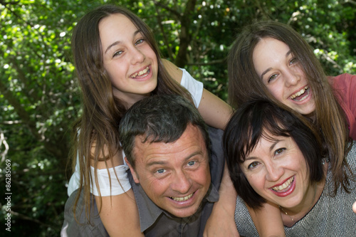 Happy loving family of 4, parents and twin