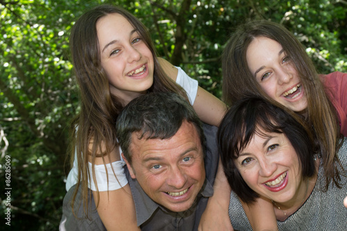 Happy loving family of 4  parents and twin