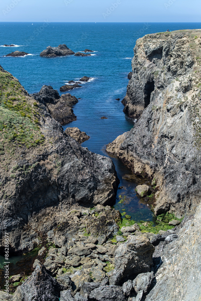 cliff of the wild coast of a brittany island dropping into the ocean