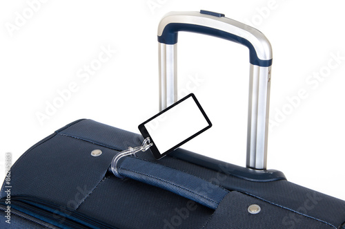 Travel suitcase close up isolated on white with blank name tag